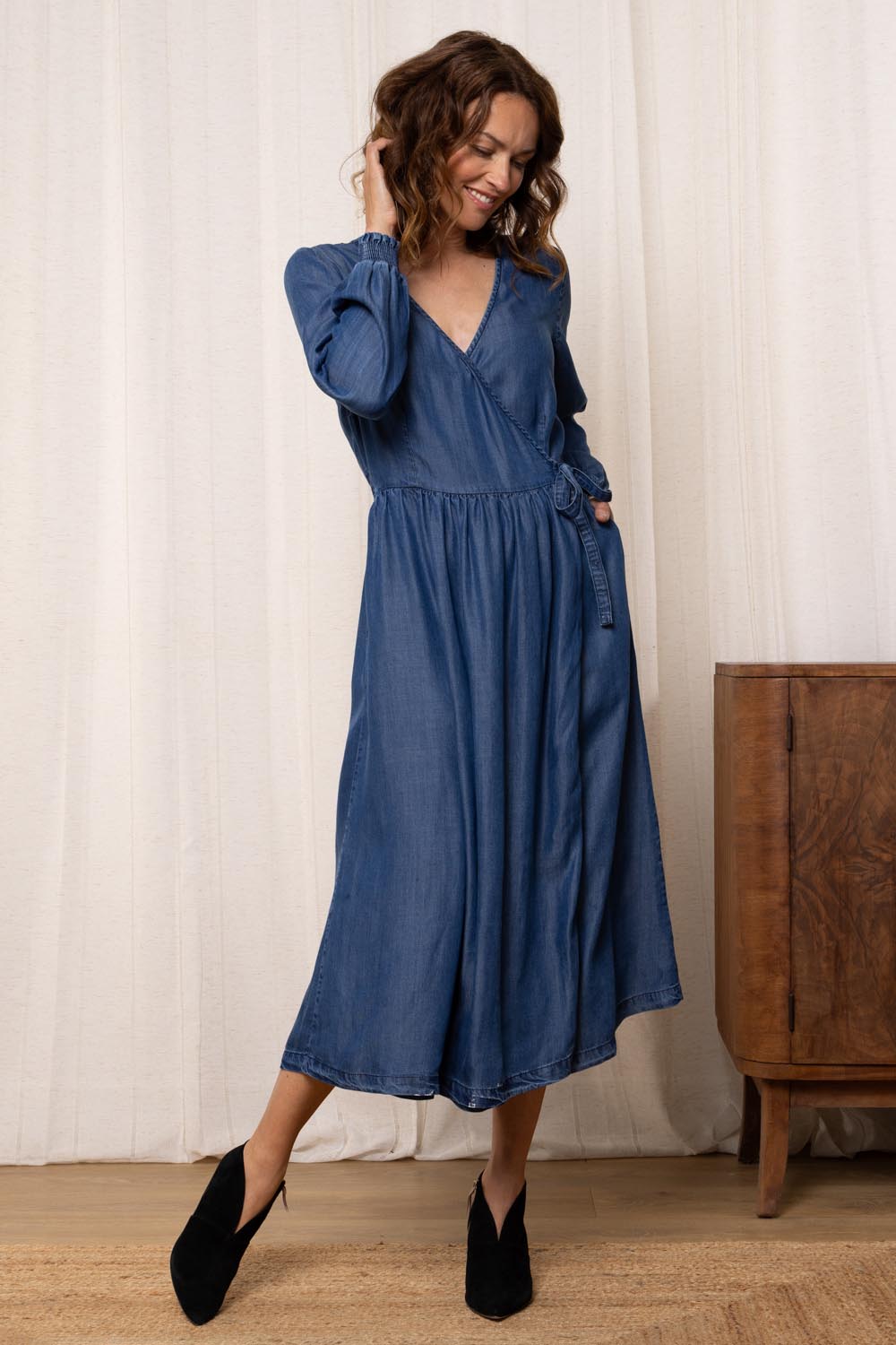 A model wearing the Christine Tencel Dress in colour Blue (Blue), from the front, showing the whole outfit