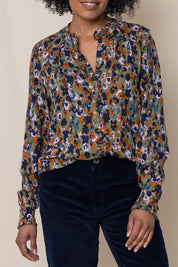 A model wearing the Rita Frill Shirt Floral Ikat in colour Olive (Green), from the front, cropped image