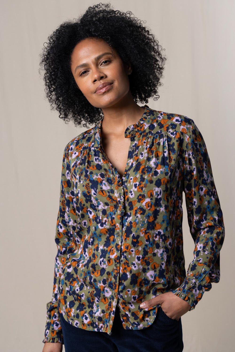 A model wearing the Rita Frill Shirt Floral Ikat in colour Olive (Green), from the front, cropped image