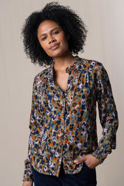 A model wearing the Rita Frill Shirt Floral Ikat in colour Olive (Green), from the front, cropped image