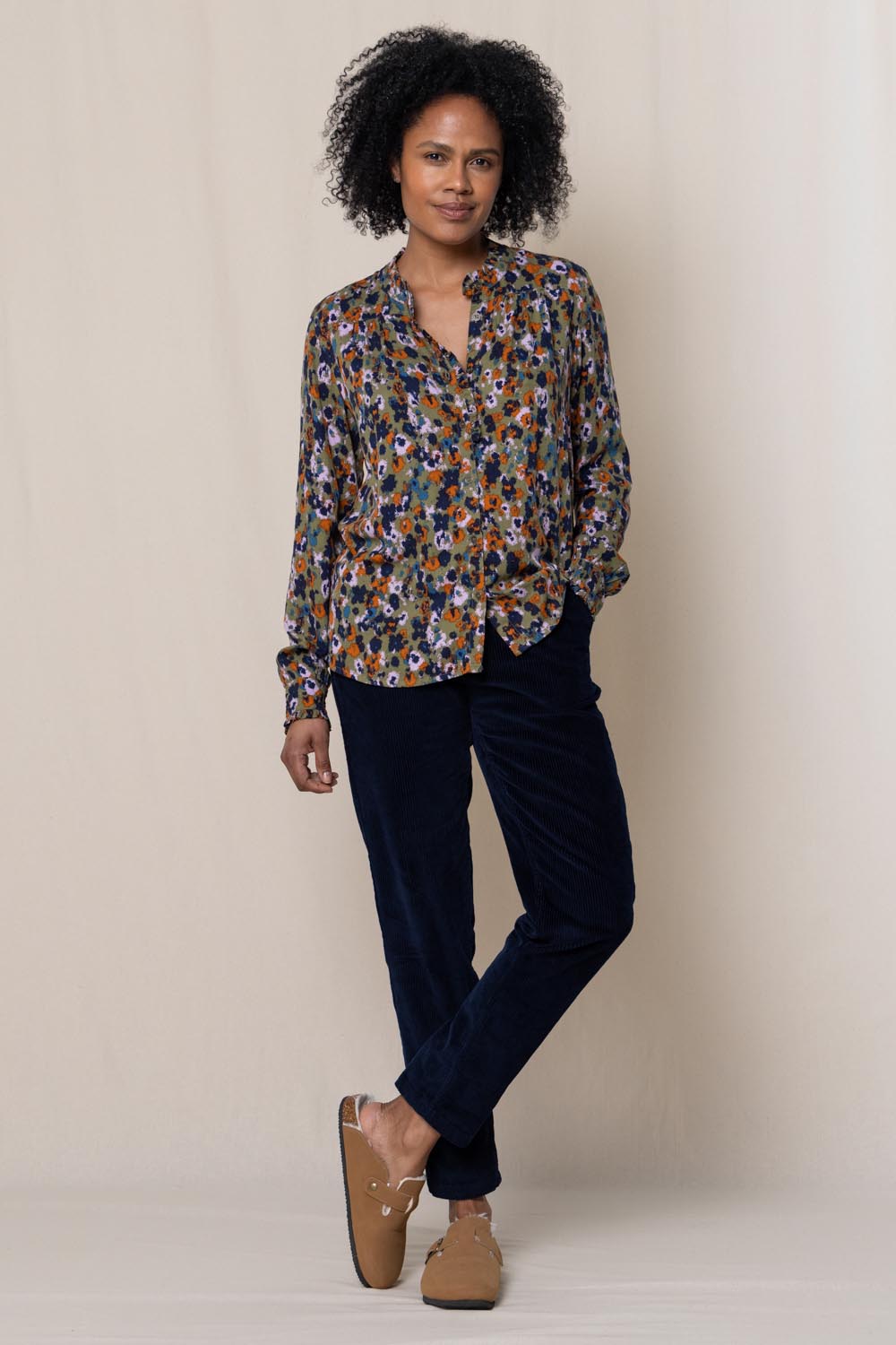 A model wearing the Rita Frill Shirt Floral Ikat in colour Olive (Green), from the front, showing the whole outfit