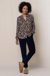 A model wearing the Rita Frill Shirt Floral Ikat in colour Olive (Green), from the front, showing the whole outfit