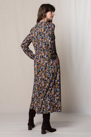 A model wearing the Seasons Dress in colour Olive (Green), from the back
