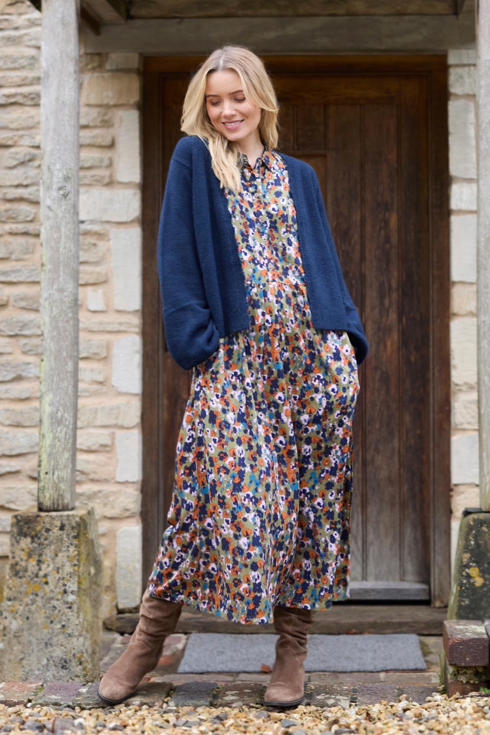 A model wearing the Seasons Dress in colour Olive (Green), from the front, showing the whole outfit