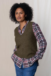 A model wearing the Laurel Tank in colour Olive (Green), from the front, cropped image
