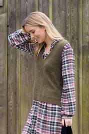 A model wearing the Laurel Tank in colour Olive (Green), from the front, showing the whole outfit