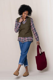 A model wearing the Laurel Tank in colour Olive (Green), from the front, showing the whole outfit