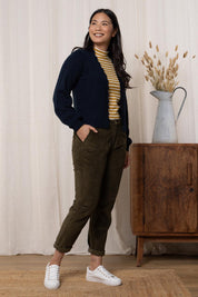 A model wearing the Helene Cardigan in colour Navy (Blue), from the front, showing the whole outfit