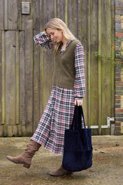 A model wearing the Ellington Check Dress in colour Mulberry (Red), from the front, showing the whole outfit