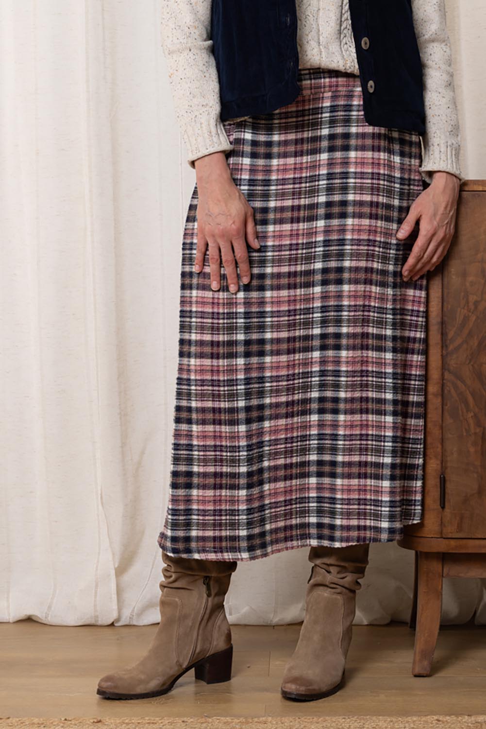 A model wearing the Alice Check Skirt in colour Mulberry (Red), from the front, cropped image