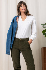 A model wearing the Bette Cotton Top in colour White (White), from the front, showing the whole outfit