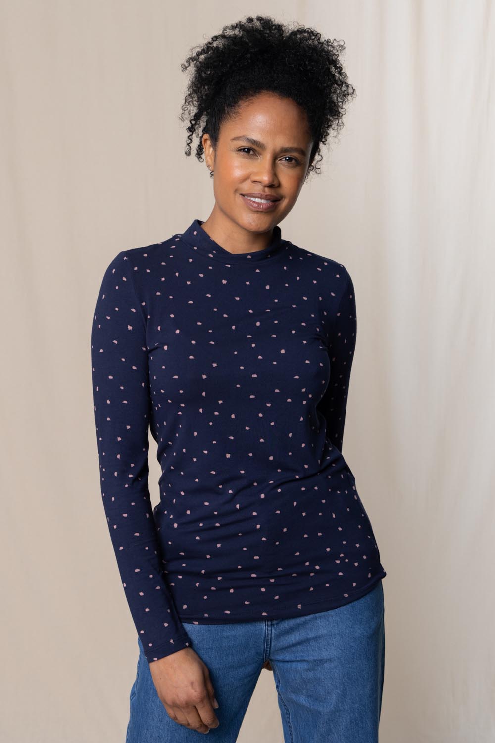 A model wearing the Ruth Turtle Neck Top Paintbrush in colour Navy (Blue), from the front, cropped image