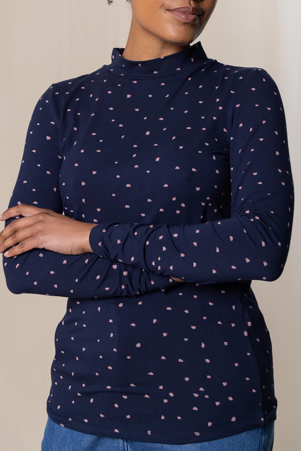 A model wearing the Ruth Turtle Neck Top Paintbrush in colour Navy (Blue), from the front, cropped image