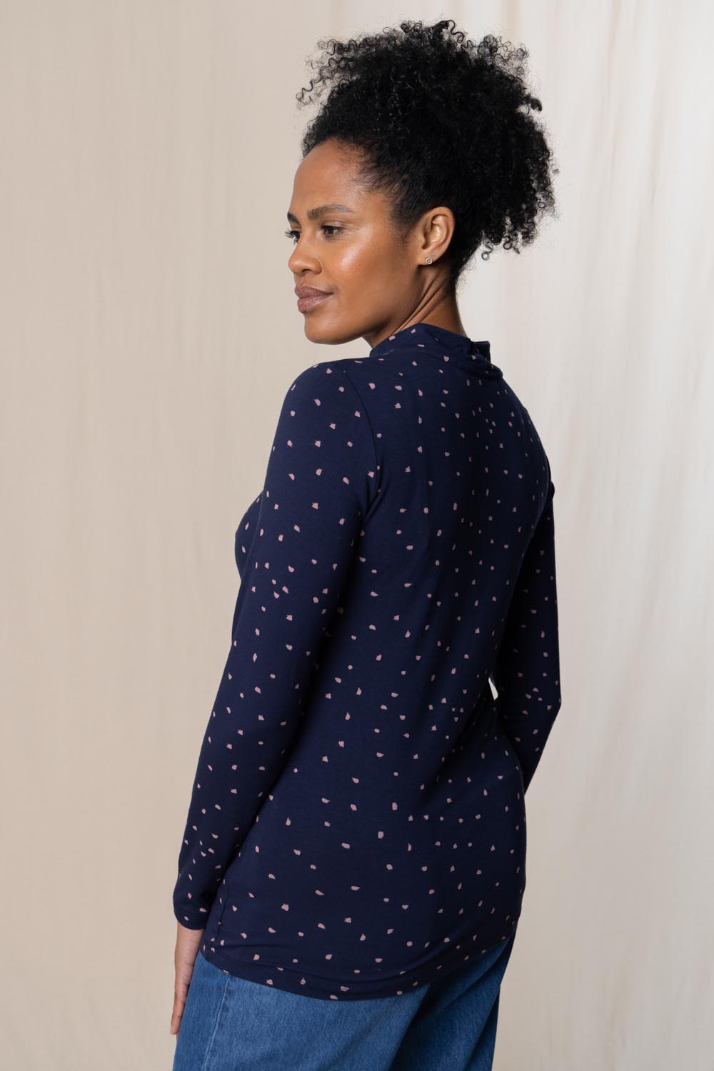 A model wearing the Ruth Turtle Neck Top Paintbrush in colour Navy (Blue), from the front, cropped image