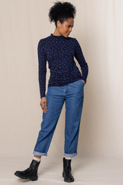 A model wearing the Ruth Turtle Neck Top Paintbrush in colour Navy (Blue), from the front, showing the whole outfit