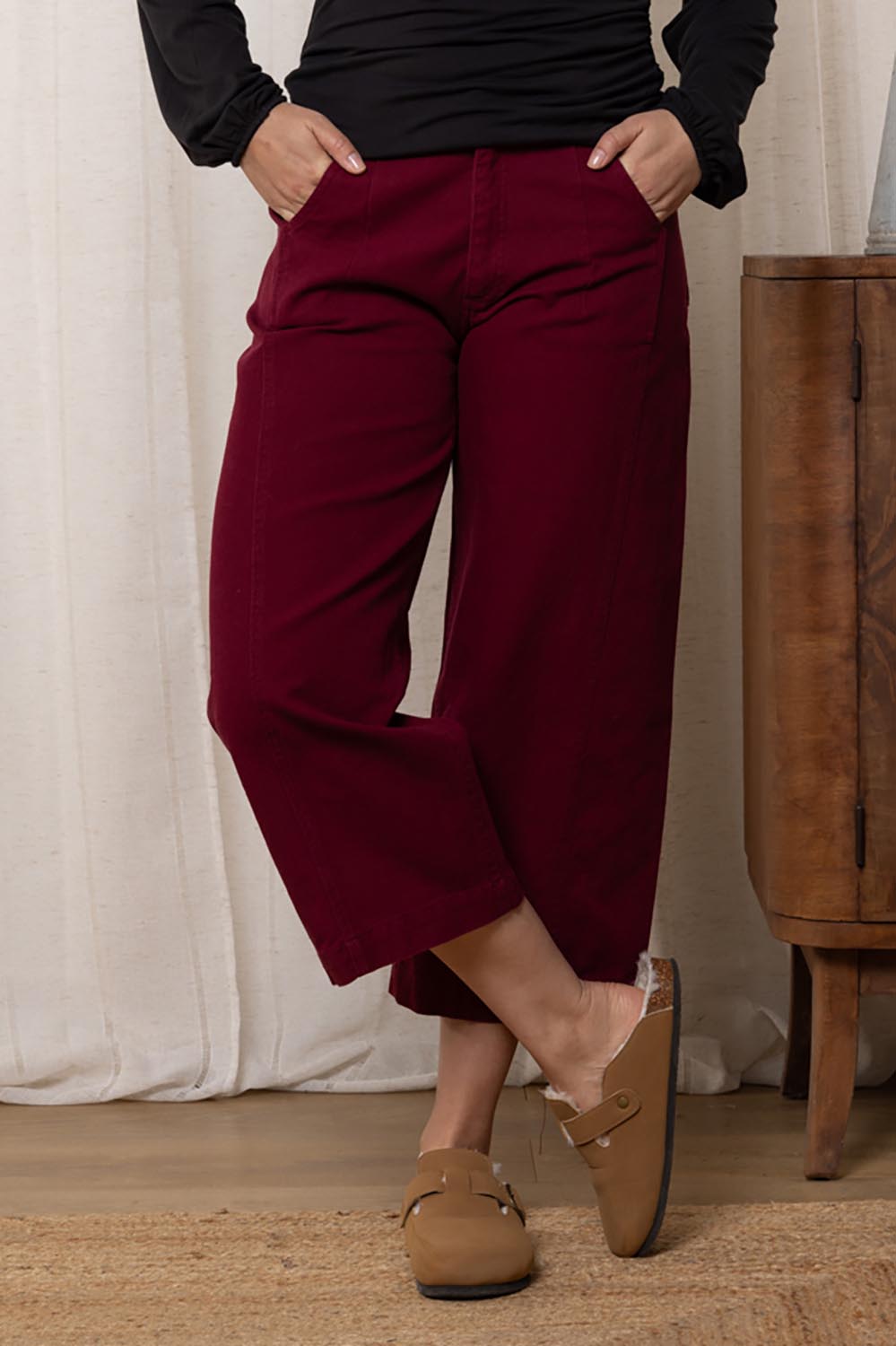 A model wearing the Charlie Cotton Canvas Trouser in colour Mulberry (Red), from the front, cropped image