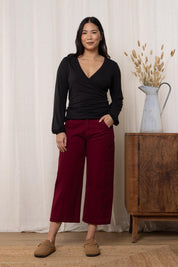 A model wearing the Charlie Cotton Canvas Trouser in colour Mulberry (Red), from the front, showing the whole outfit