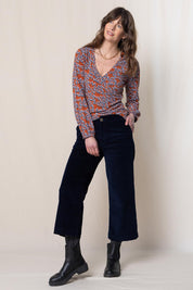 A model wearing the Isla Crop Cotton Cord Trouser in colour Navy (Blue), from the front, showing the whole outfit