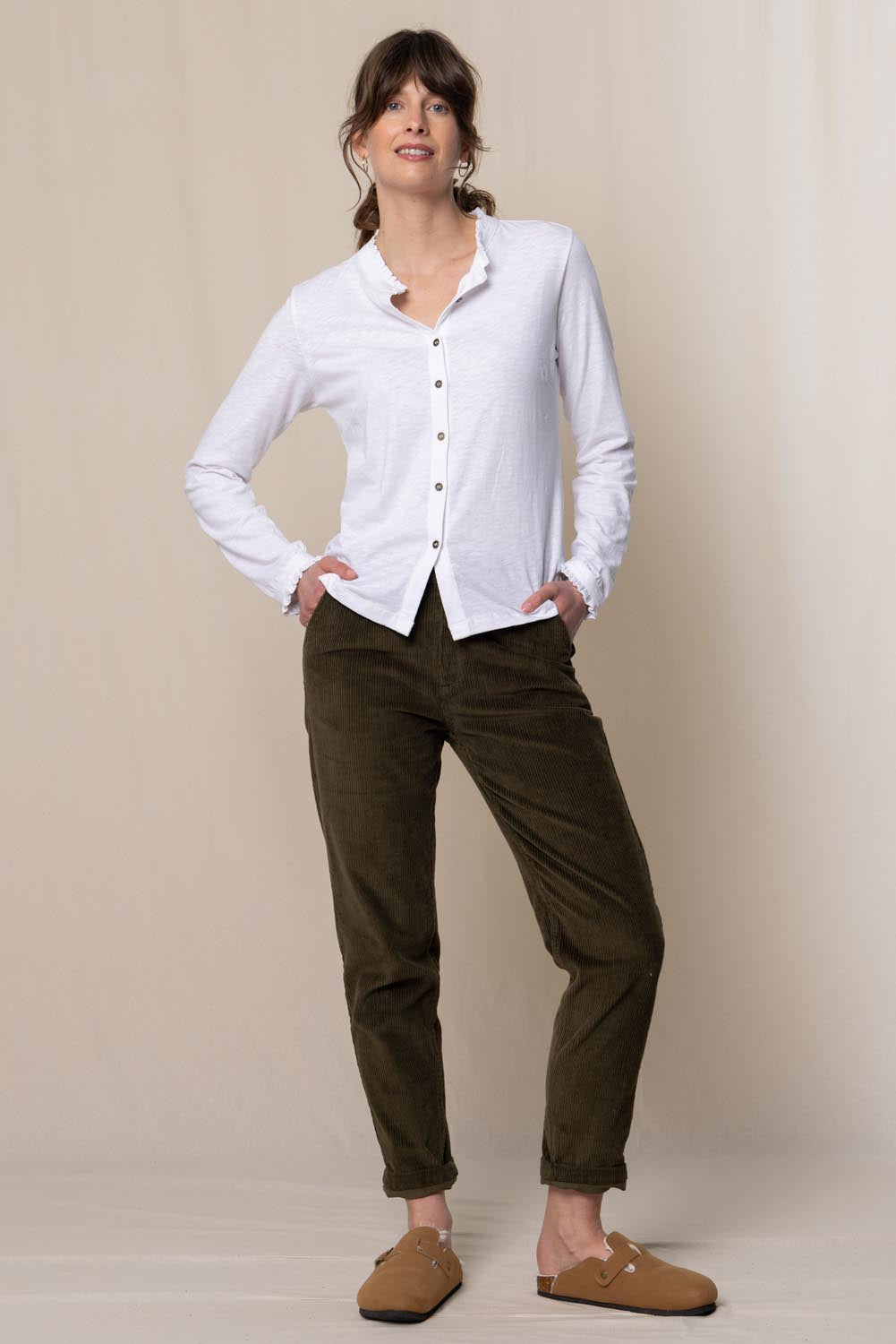 A model wearing the Brookend Cotton Cord Trouser in colour Olive (Green), from the front, showing the whole outfit