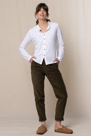 A model wearing the Brookend Cotton Cord Trouser in colour Olive (Green), from the front, showing the whole outfit