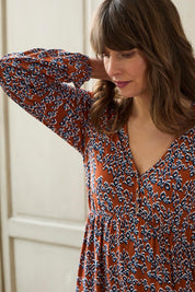 A model wearing the Lillian Dress Animal Stamp in colour Ginger, from the front, cropped image