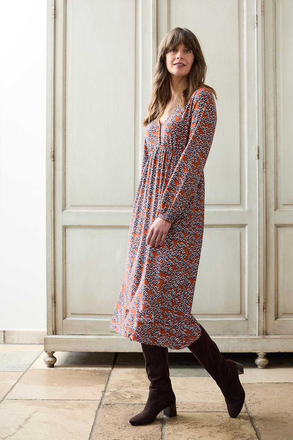 A model wearing the Lillian Dress Animal Stamp in colour Ginger, from the front, showing the whole outfit