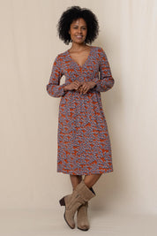 A model wearing the Lillian Dress Animal Stamp in colour Ginger, from the front, showing the whole outfit