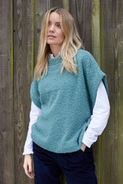 A model wearing the Tabitha Button Wool Blend Poncho in colour Duckegg (Blue), from the front, showing the whole outfit