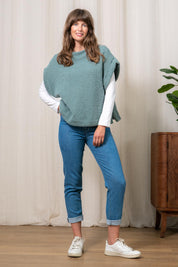 A model wearing the Tabitha Button Wool Blend Poncho in colour Duckegg (Blue), from the front, showing the whole outfit