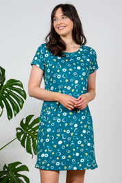 A model wearing the Heather Dress in colour Darkteal (Green), from the front, cropped image