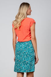 A model wearing the Everyday Linen Skirt in colour Darkteal (Green), from the back
