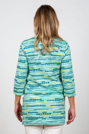 A model wearing the Harriet Tunic in colour Seafoam (Green), from the back