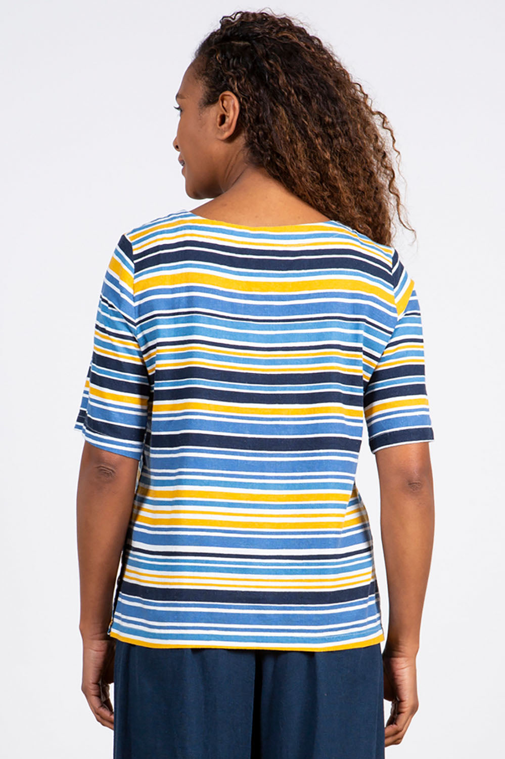 A model wearing the Buttercup Top in colour Bluestripe (Blue), from the back