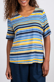 A model wearing the Buttercup Top in colour Bluestripe (Blue), from the front, cropped image