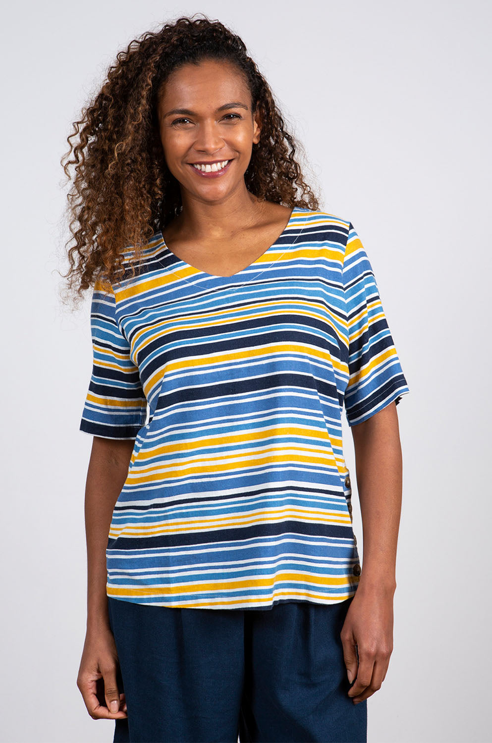 A model wearing the Buttercup Top in colour Bluestripe (Blue), from the front, cropped image