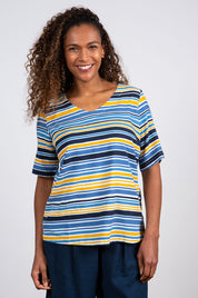 A model wearing the Buttercup Top in colour Bluestripe (Blue), from the front, cropped image