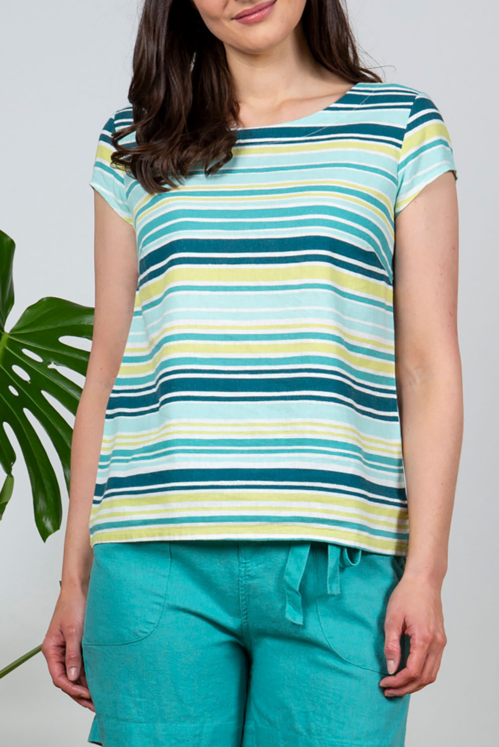 A model wearing the Sun And Shade Top in colour Tealstrip (Green), from the front, cropped image