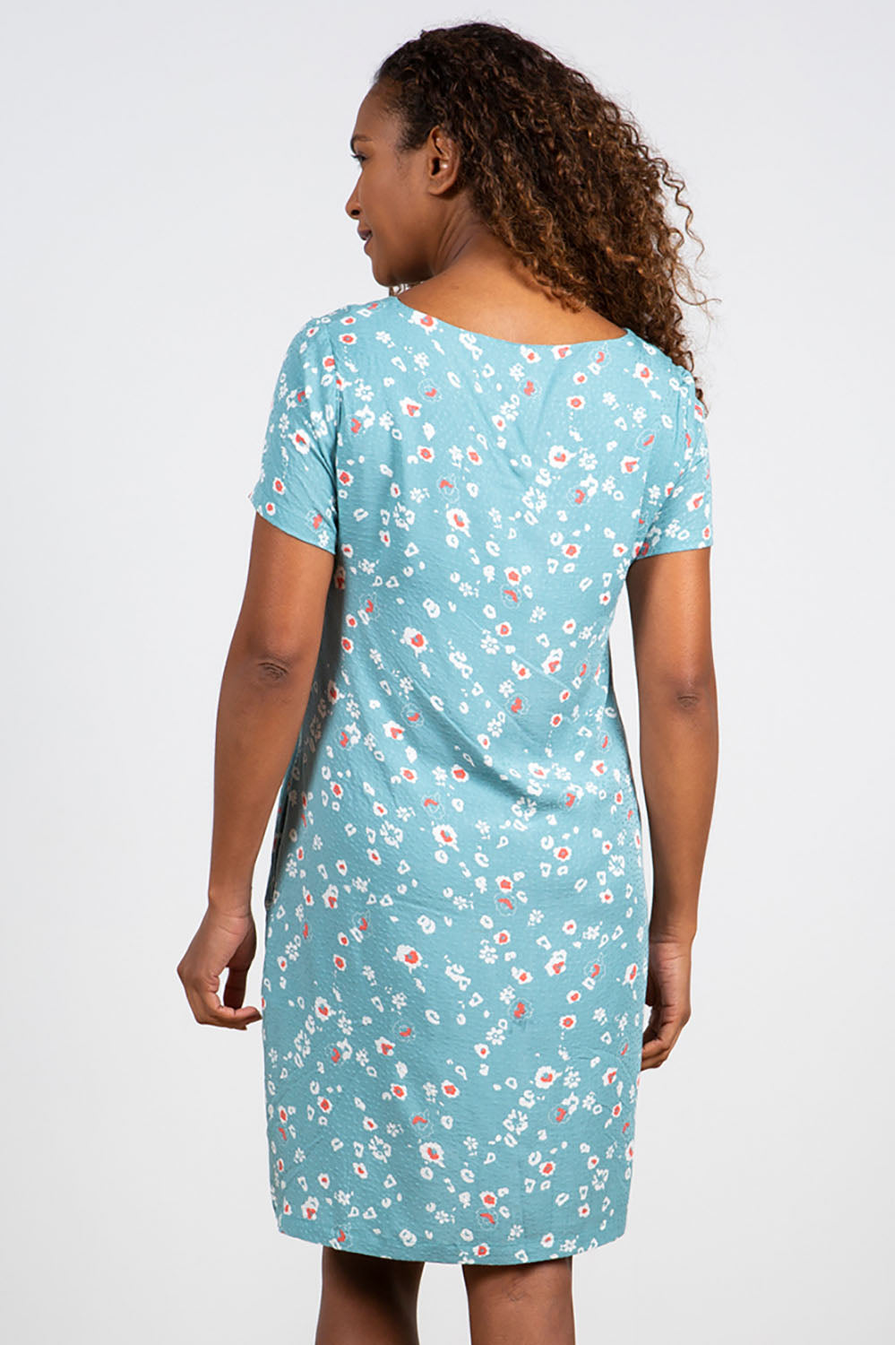 A model wearing the Seascape Dress in colour Seafoam (Blue), from the back