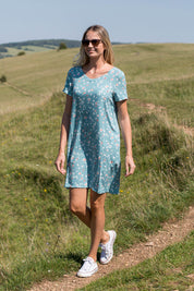 A model wearing the Seascape Dress in colour Seafoam (Blue), from the front, showing the whole outfit