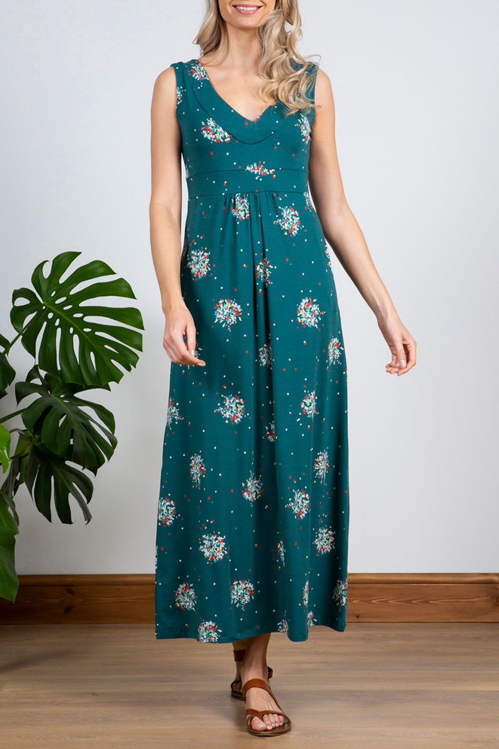 A model wearing the Chrissy Maxi Dress in colour Darkteal (Green), from the front, cropped image