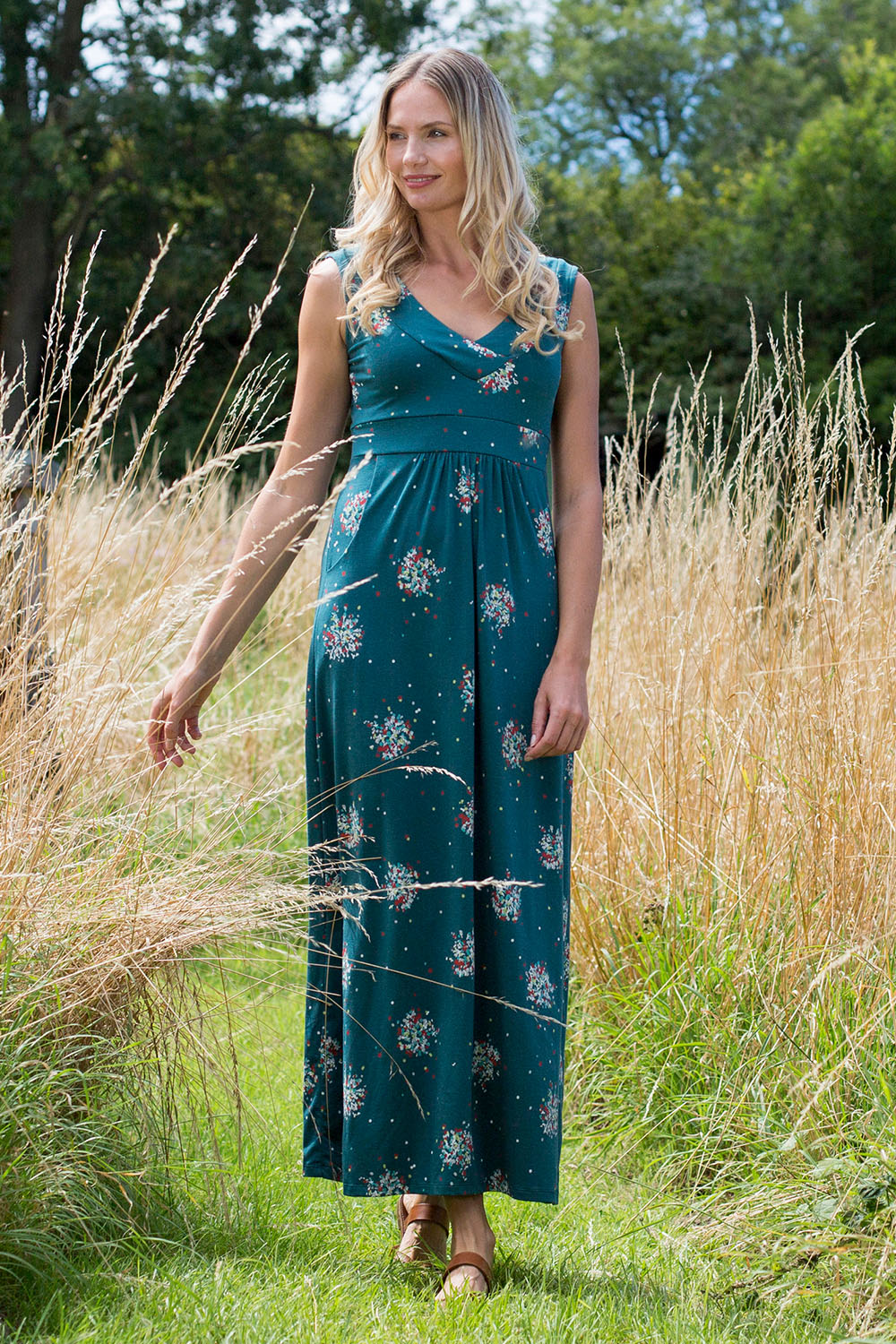 A model wearing the Chrissy Maxi Dress in colour Darkteal (Green), from the front, showing the whole outfit