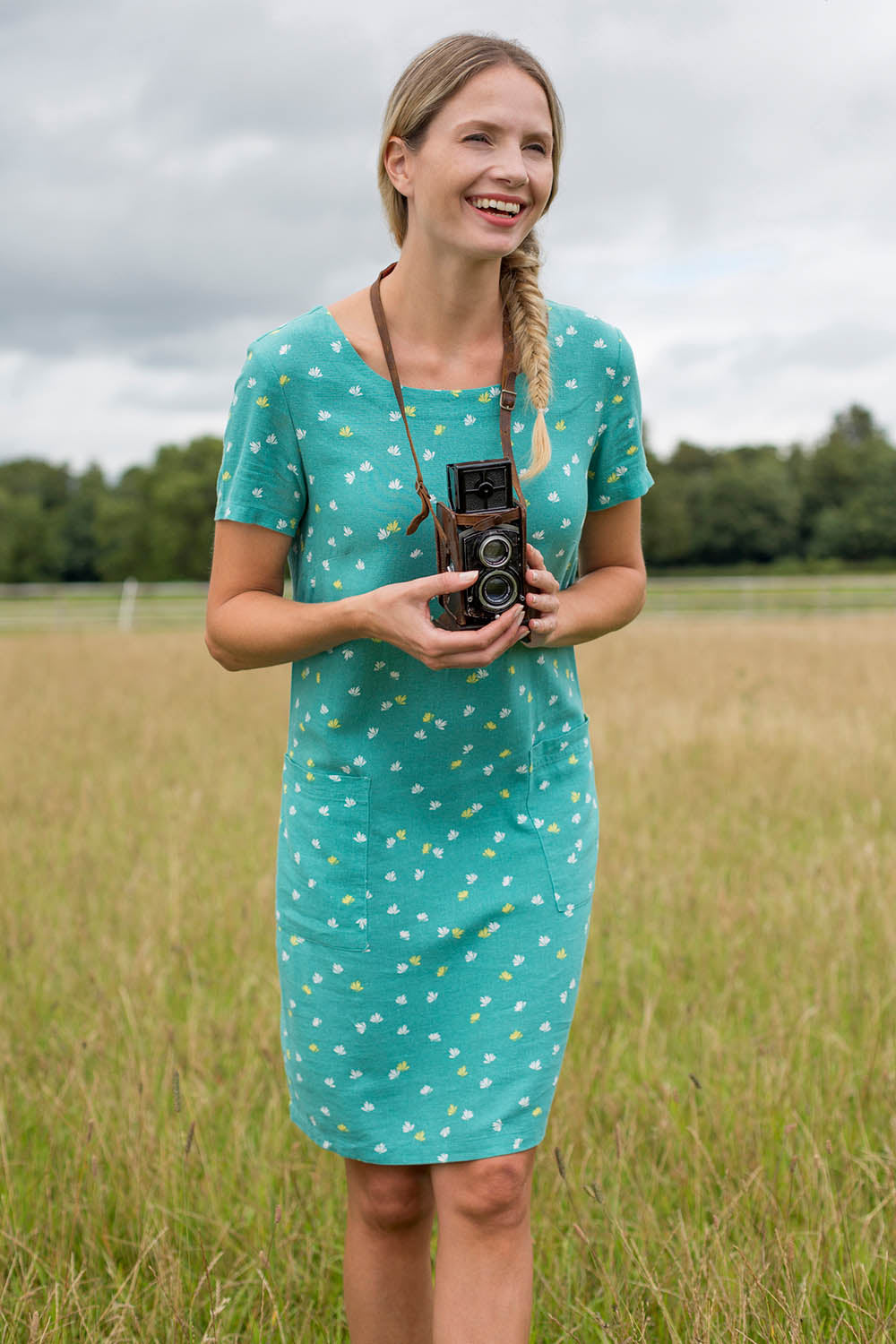 A model wearing the Pocket Dress in colour Turquoise (Green), from the front, showing the whole outfit