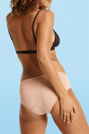 A model wearing the Midi Brief in colour Beige, from the back
