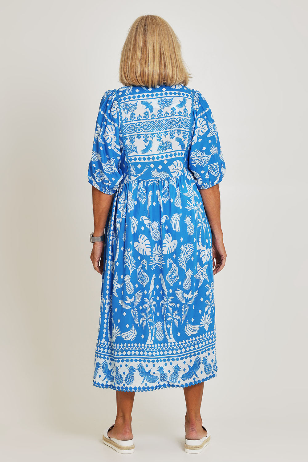 Model Sandy wearing size S of the Agatha Midi Cotton Dress in colour Ocean (Blue), from the back