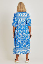 Model Sandy wearing size S of the Agatha Midi Cotton Dress in colour Ocean (Blue), from the back