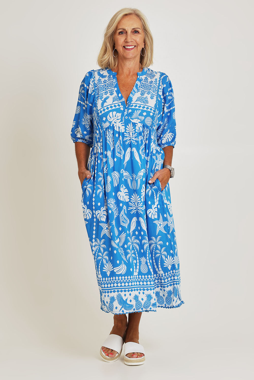 Model Sandy wearing size S of the Agatha Midi Cotton Dress in colour Ocean (Blue), from the front, showing the whole outfit