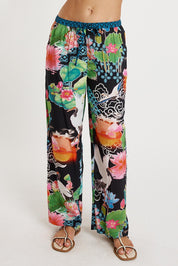 A model wearing the Akiko Pant in colour Ocean, from the front, cropped image