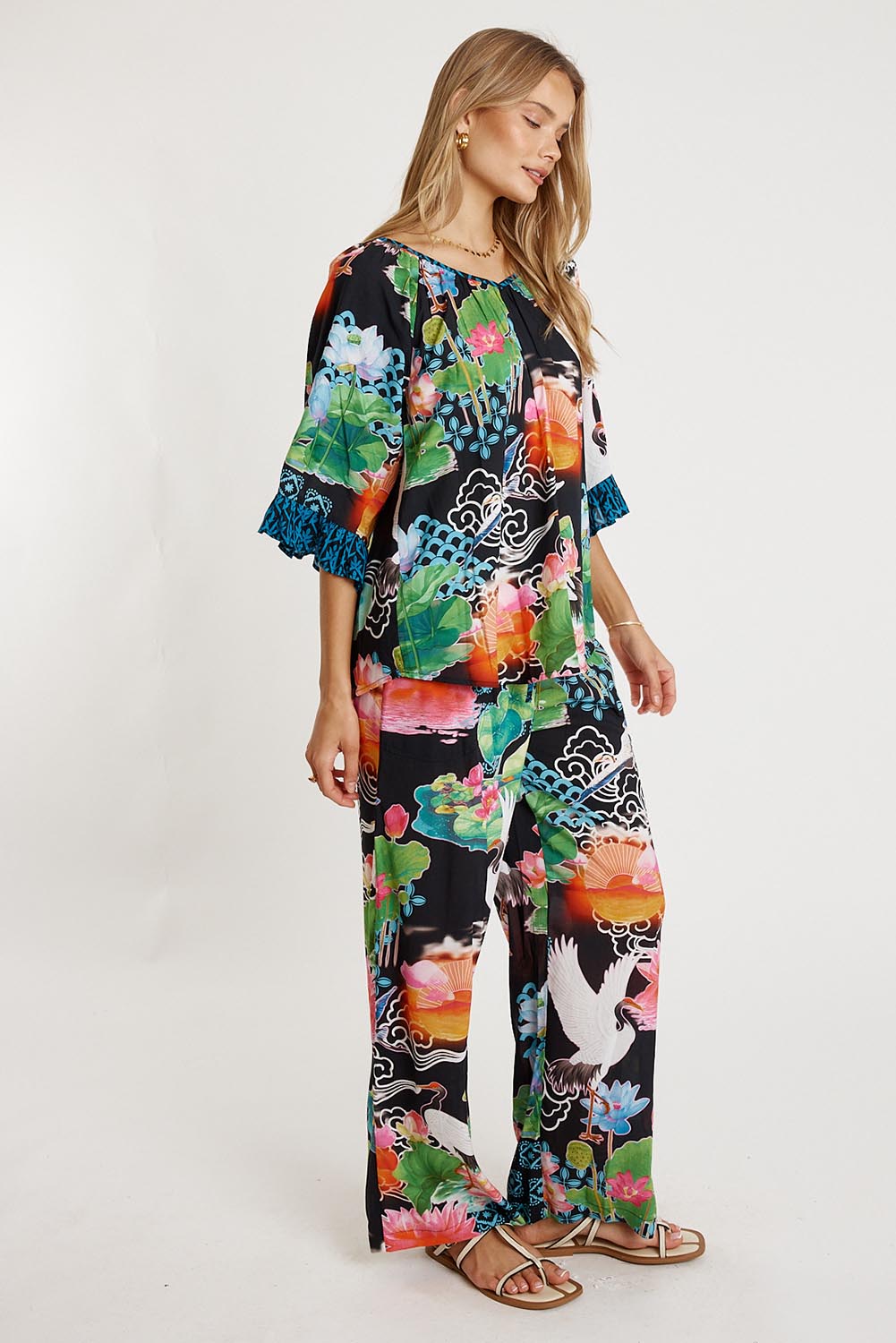 A model wearing the Akiko Pant in colour Ocean, from the front, showing the whole outfit