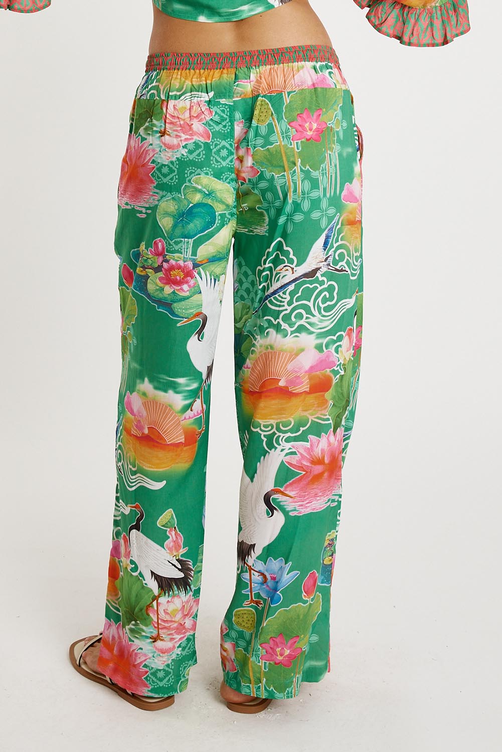 A model wearing the Akiko Pant in colour Sea (Green), from the back