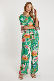 A model wearing the Akiko Pant in colour Sea (Green), from the front, showing the whole outfit